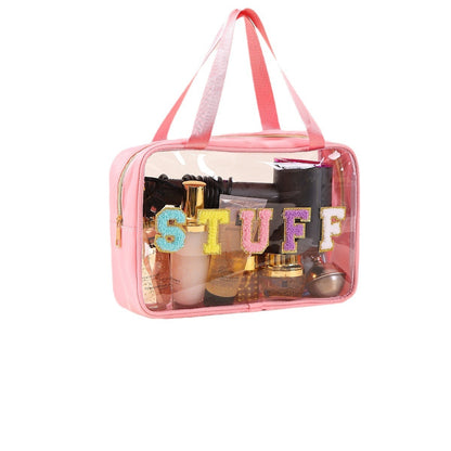 Clear pink travel cosmetic bag with handles and decorative STUFF lettering